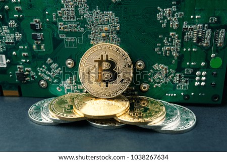 bitcoin on the video card, bitcoin coin on the table near the computer board, a lot of free space