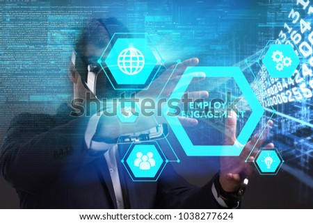Business, Technology, Internet and network concept. Young businessman working in virtual reality glasses sees the inscription: Employee engagement