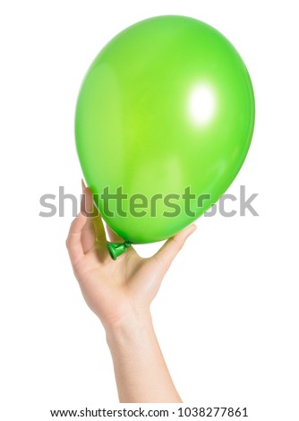 Close-up Of Hand Holding Green Balloon Over White Background