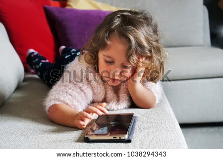 baby girl playing with mobile phone