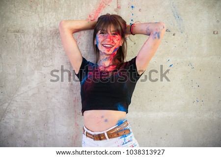 Beautiful young girl with color holi