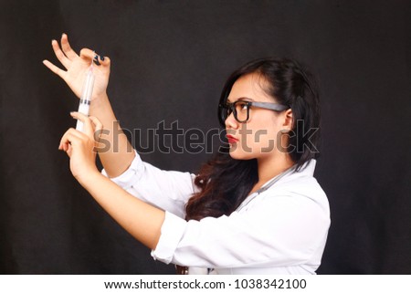 asian doctor injection check. Female doctor holding injection. Female doctor with injection