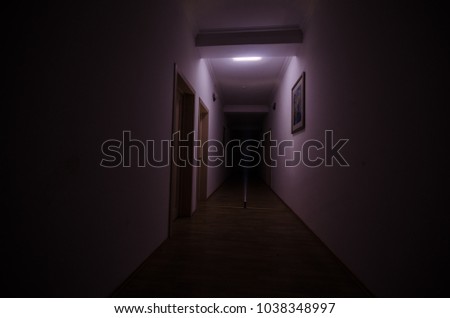 Dark corridor with cabinet doors and freezelight figures on it. Horror Concept.