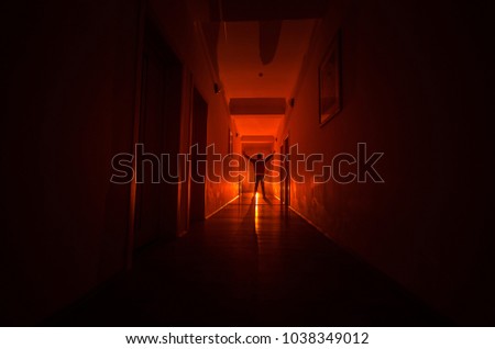 Dark corridor with cabinet doors and lights with silhouette of spooky horror man standing with different poses. Halloween concept