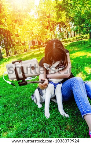 A sincere photo of a girl and her dog on the street in the park
