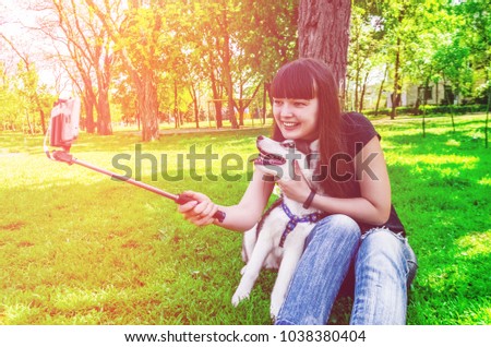 Sitting on grass girl wants to be photographed with her dog