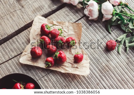 Breakfast with strawberries and flowers on the rustic table. Healthy breakfast, Clean eating, vegan food concept. Top view