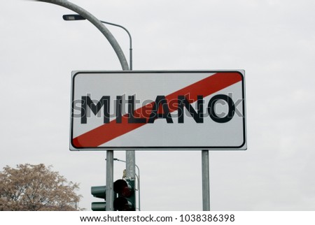 road sign symbol with inscription "Milano" barred with red, indicates that going in that direction you are leaving the city of Milan, direction or street opposite the old town, winter, Italy