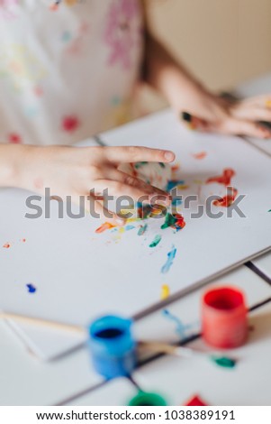 Close up of girls hands painting easter eggs