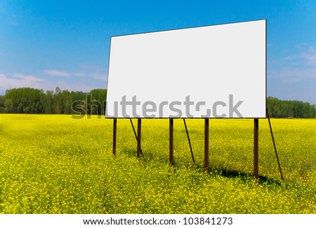Empty billboard for your advertise on yellow rapeseed flower field