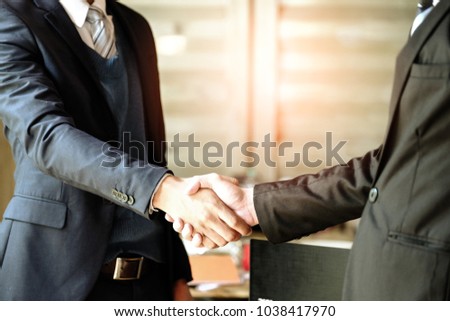 Business partnership meeting concept.Image of businessmen handshake. Successful businessmen handshaking after good deal. Horizontal, blurred background.Congratulation, merger and acquisition concepts.
