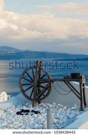 wooden wheel and aegean sea oia santorini greece