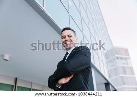 Portrait of happy businessman with arms crossed