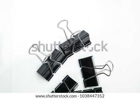 Black paper clips on white
