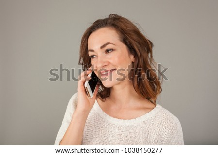 brunette young women receiving good news and is happy on the phone