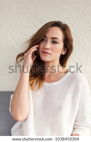 beautiful girl in withe dress calling somebody portrait