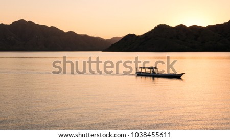 Fisherman Sailing through the Islands of Komodo National Park at Dusk, Indonesia (Widescreen)