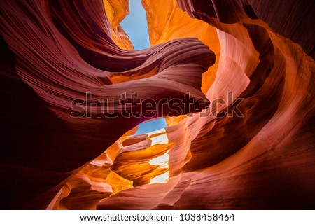 Beautiful wide angle view of amazing sandstone formations in famous Antelope Canyon on a sunny day with blue sky near the old town of Page at Lake Powell, American Southwest, Arizona, USA Royalty-Free Stock Photo #1038458464