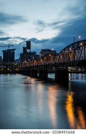 Hawthorne bridge leading towards downtown Portland, Oregon at dusk