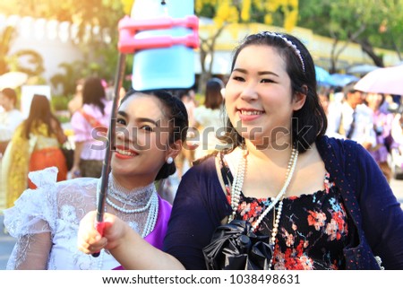 lady take a picture happily,portrait chubby woman cute taking selfie by smartphone so happiness in park,two women take a photo in congratulation to her friend,holiday and recreation with photography,