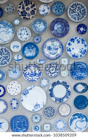 Ceramic plate on the wall at coffee shop. Royalty-Free Stock Photo #1038509209