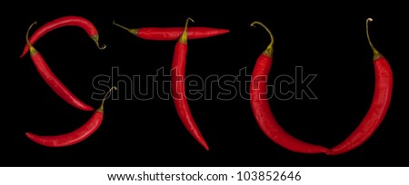 letters from red chili peppers isolated on black background