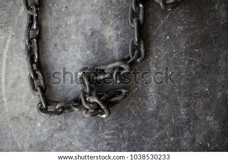 Old black chain on the floor