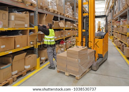 Worker Order Picking in Fulfillment Warehouse Royalty-Free Stock Photo #1038530737