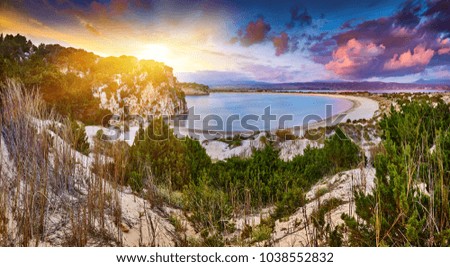 Amazing sunset view with multicolored clouds. Incredibly romantic sunrise on Voidokilia beach, Ionian Sea, Pilos town location, Greece, Europe. View of the ocean. Tropical beach