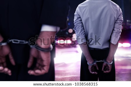 Two businessman in handcuffs Royalty-Free Stock Photo #1038568315