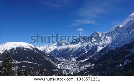 Amazing pure blue view on Chamonix Valley from Les Houches ski resort, Haute-Savoie, France. Mont-Blanc Massif throning in the back, surmounted by Aiguille du Midi and Aiguille Verte in the foreground