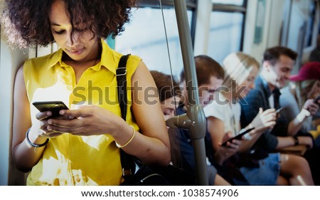 Young woman using a smartphone in a subway Royalty-Free Stock Photo #1038574906