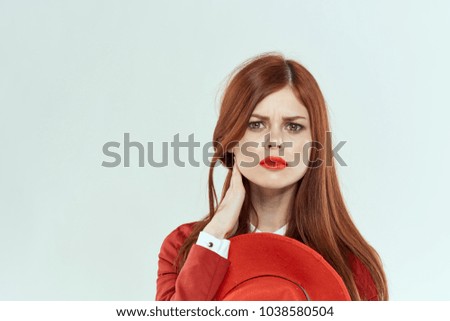 emotion, woman with red hat in hand                         
