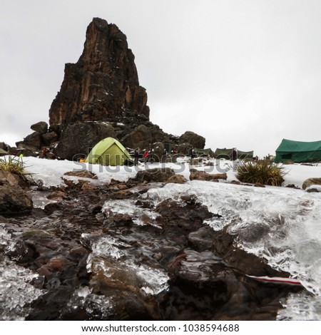 Lava tower on mount Kilimanjaro with tents for lunch stop, Africa