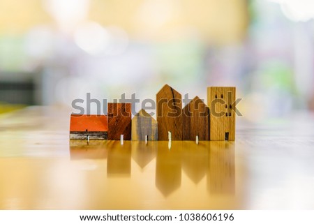 Wood house model on wood table , a symbol for construction , ecology, loan, mortgage, property or home.