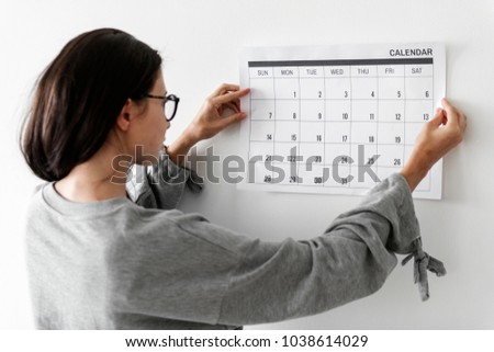 Woman checking the calendar Royalty-Free Stock Photo #1038614029