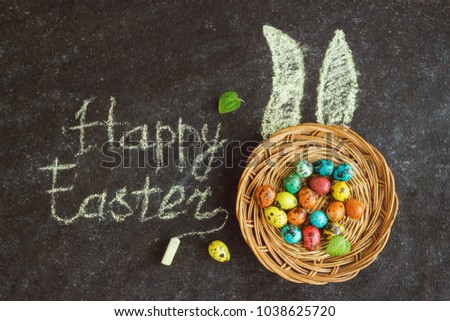 Easter colored eggs on a black background, chalk, ears, Easter concept, inscription, text