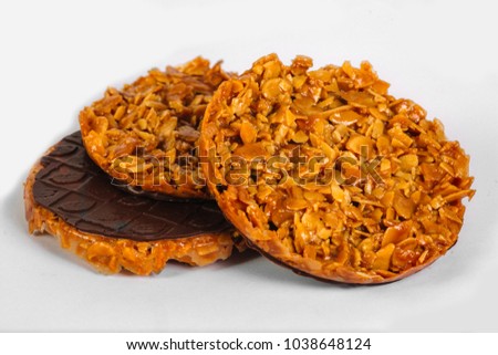 Nuts in caramel glazed with chocolate on the wooden rustic background