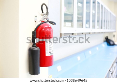 Red tank of fire extinguisher in the laboratory. Fire security system in the office