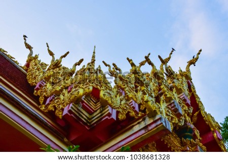 Bottom view - Kanok Laying on the roof of a temple in Thailand.