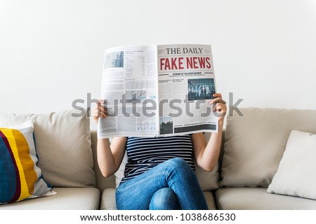 Woman reading newspaper Royalty-Free Stock Photo #1038686530
