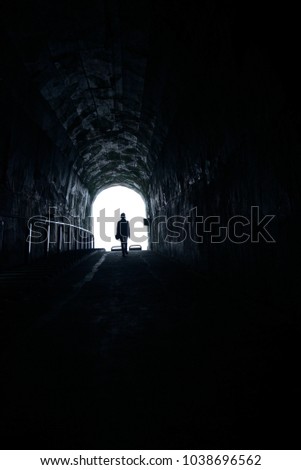 People toward the light in the tunnel.