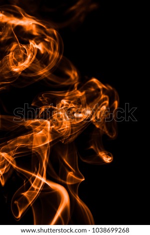 Movement of orange smoke on black background. fire design