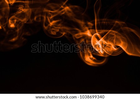 Movement of orange smoke on black background. fire design