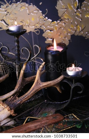 Black burning candles. Roebuck head with a knife and pentagram.