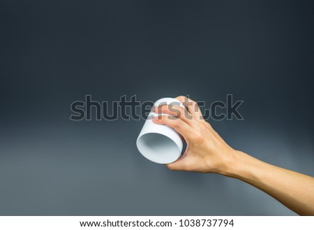 Empty coffee cup, hand holding upside down Royalty-Free Stock Photo #1038737794