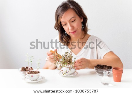 A woman making home gardening creations