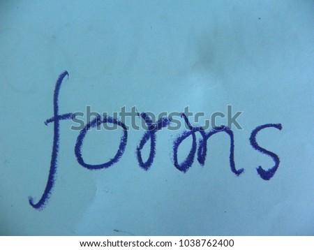 Text forms hand written by dark blue oil pastel on blue color paper