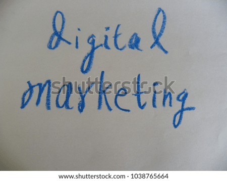 Text digital marketing hand written by blue oil pastel on white color paper