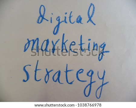 Text digital marketing strategy hand written by blue oil pastel on white color paper